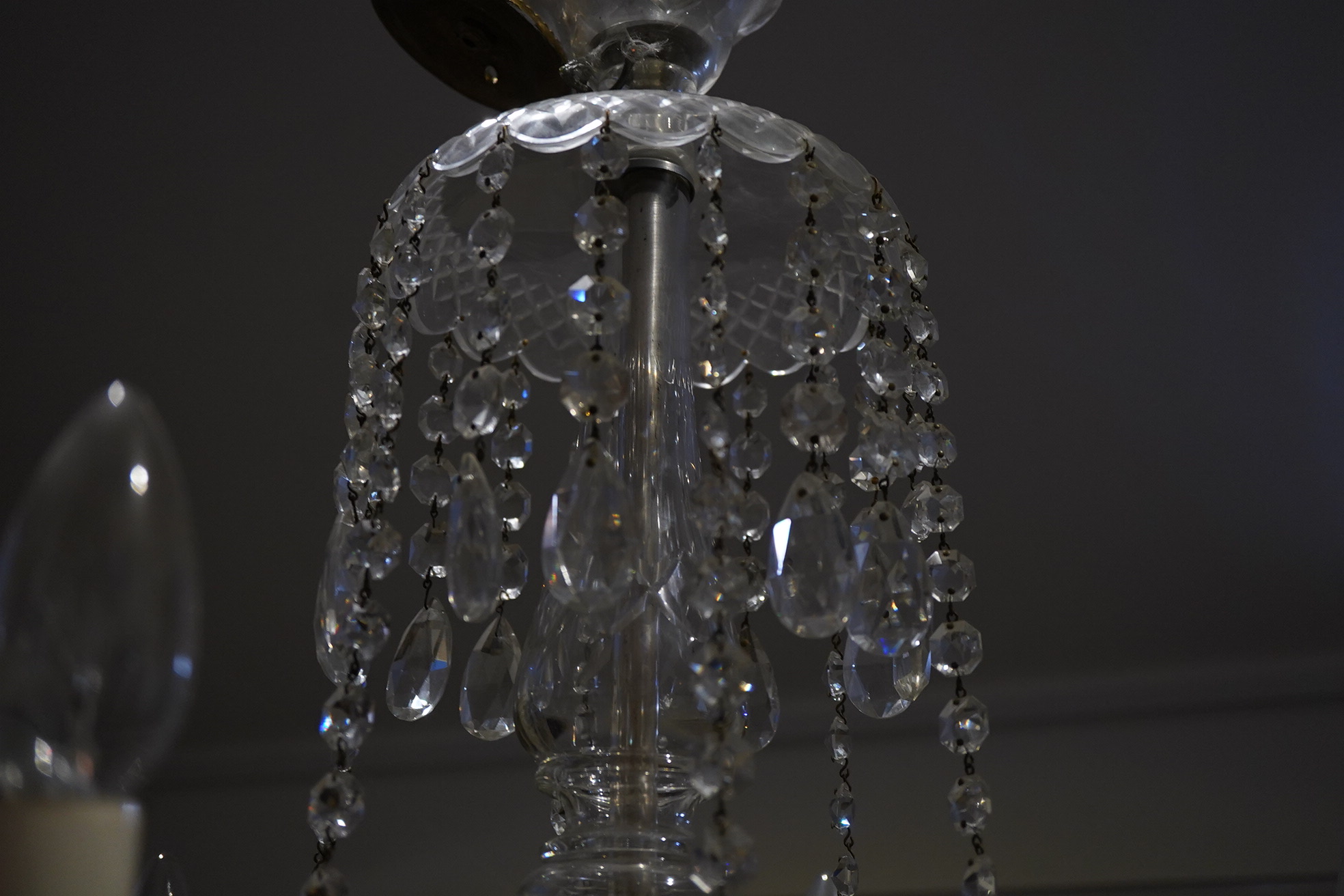 A cut glass five branch chandelier with drops